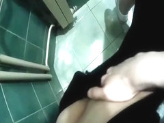 Hottie goes to the toilet to finger her tight pussy