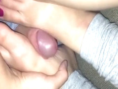 Horny guy rubs his cock between his best friend's feet