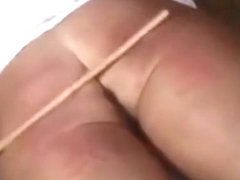 Hot girl takes a caning from two men on hands and ass