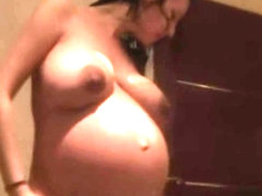 Kelly hart massages her pregnant body with a lotion after a shower